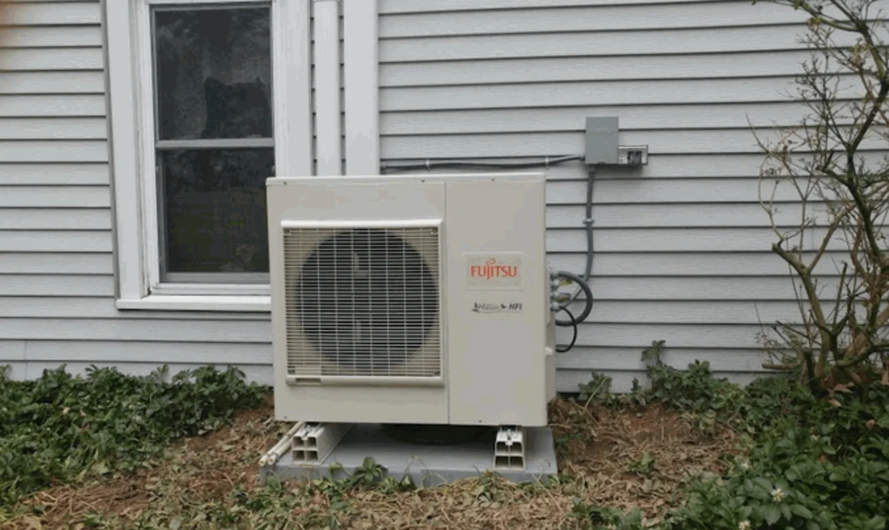 Fujitsu ductless outdoor unit mounted beside a customer's home